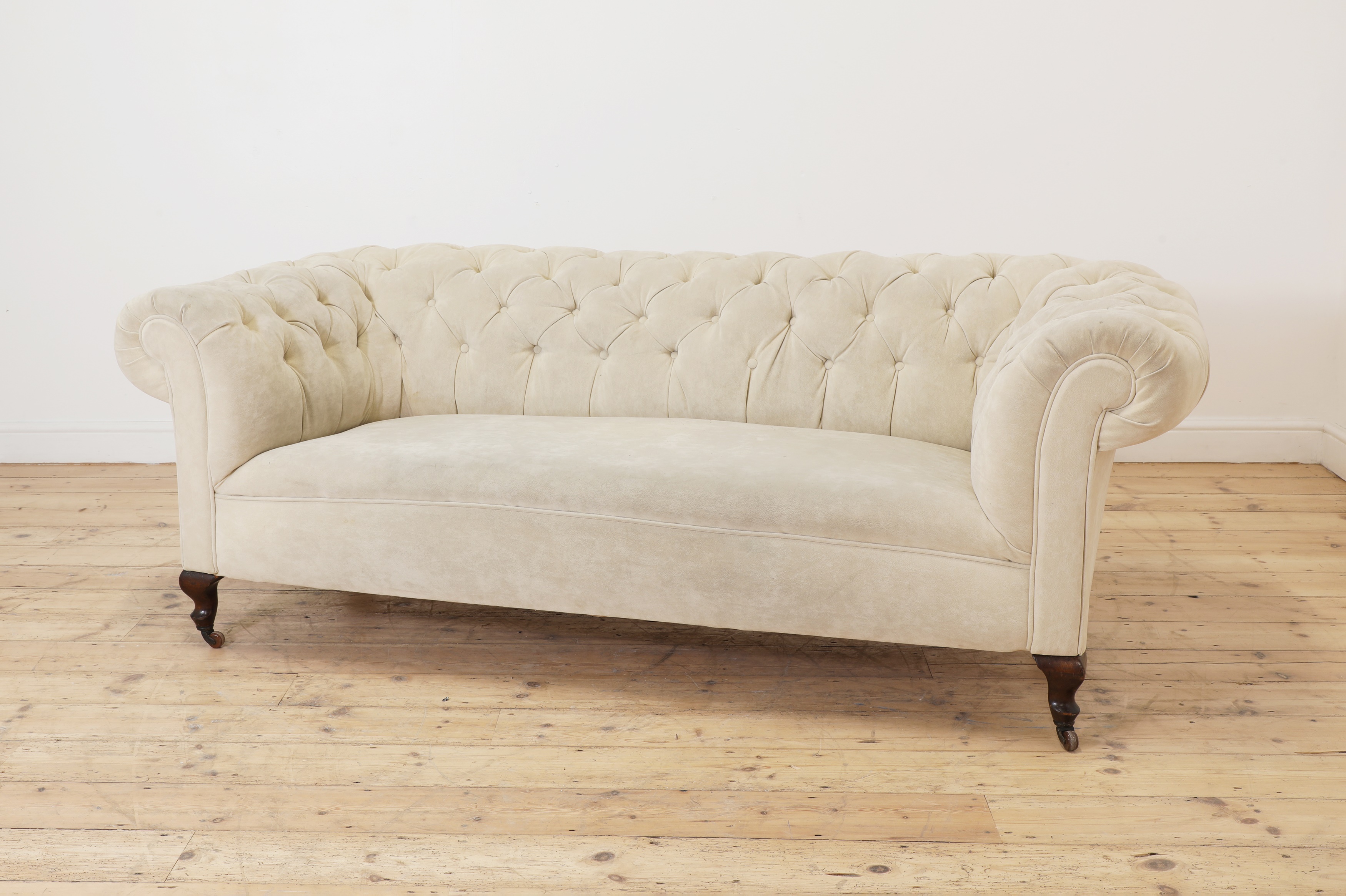 A Victorian button back synthetic suede chesterfield sofa